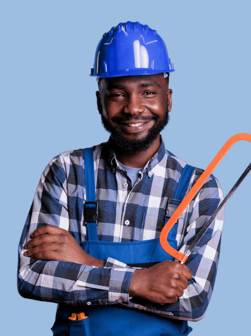 man wearing construction clothing holding a hand saw